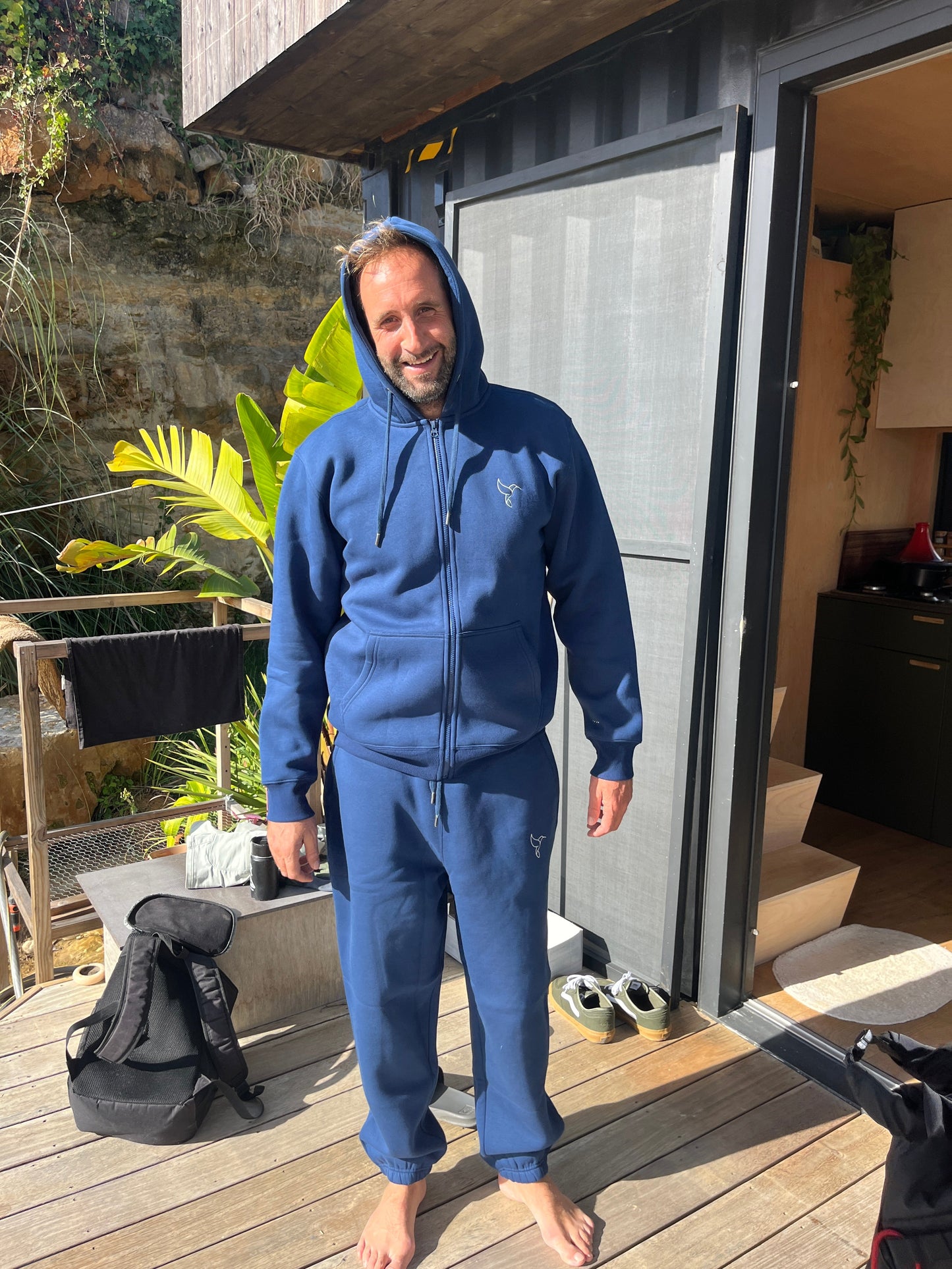 Man after surf wearing Warrior Sol Chillax Sweatpants in Midnight Blue