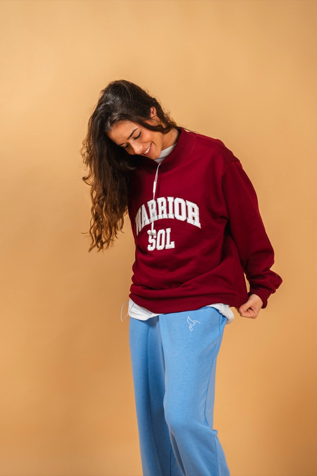 Varsity Mockneck in Berry — model wearing berry red varsity mockneck with WARRIOR SOL lettering | Warrior Sol cancer support apparel