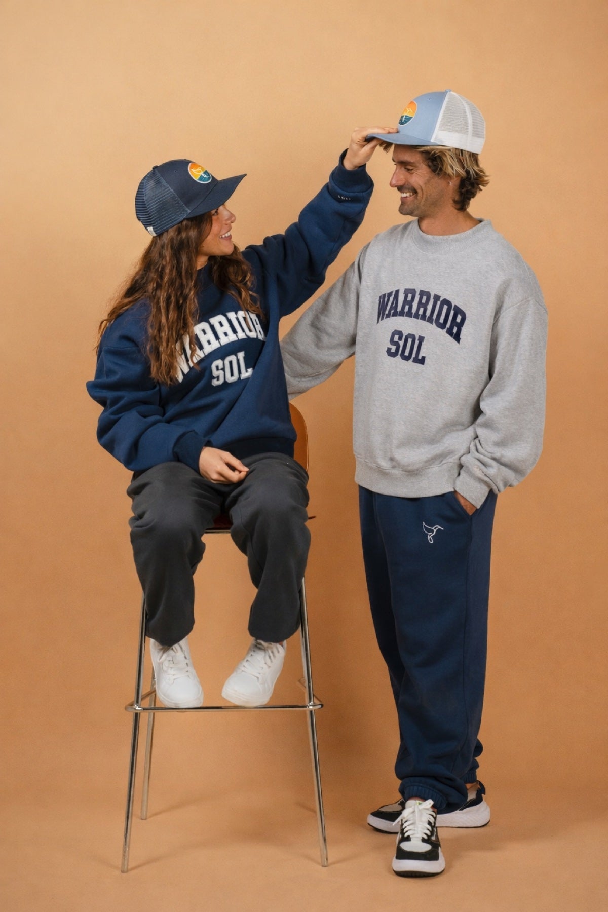 Varsity Mockneck in Moon Gray — couple wearing Warrior Sol varsity mocknecks, playful moment, warm studio | Warrior Sol cancer support apparel