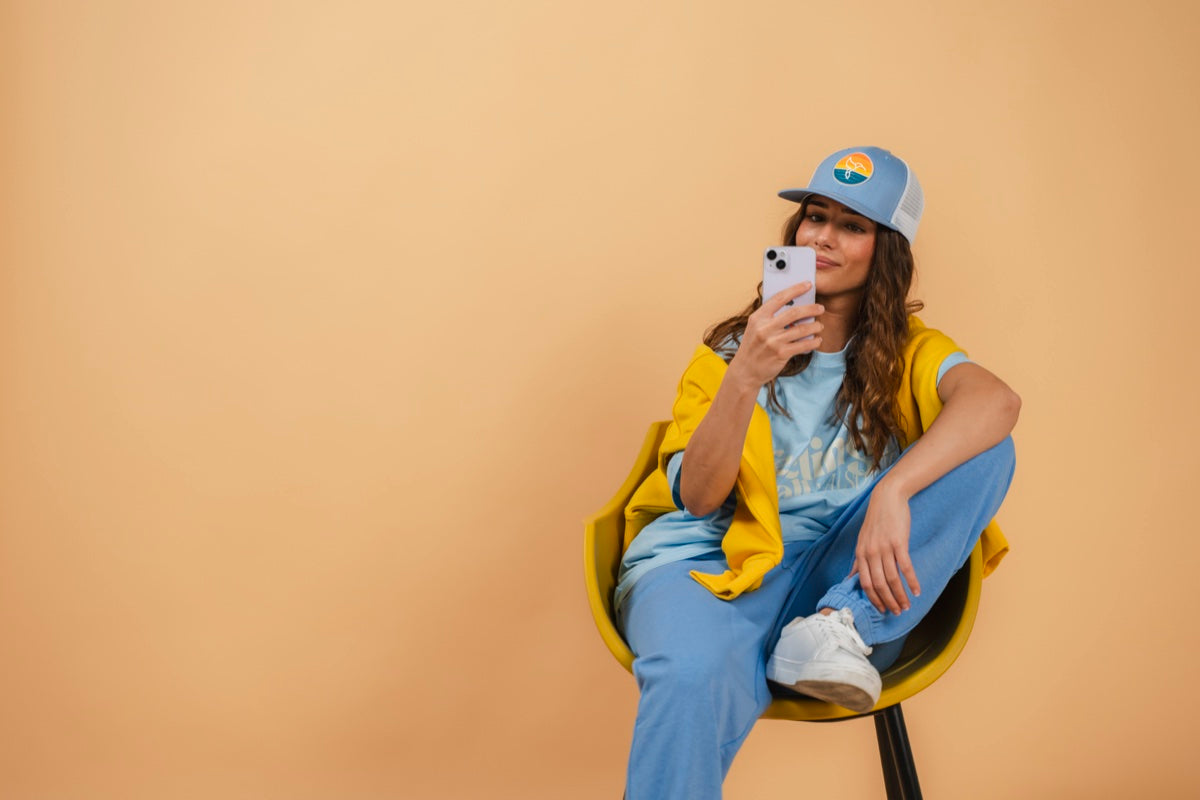 Warrior Sol All Day Sweatpants in Sky Blue model with hat and phone gold campaign background