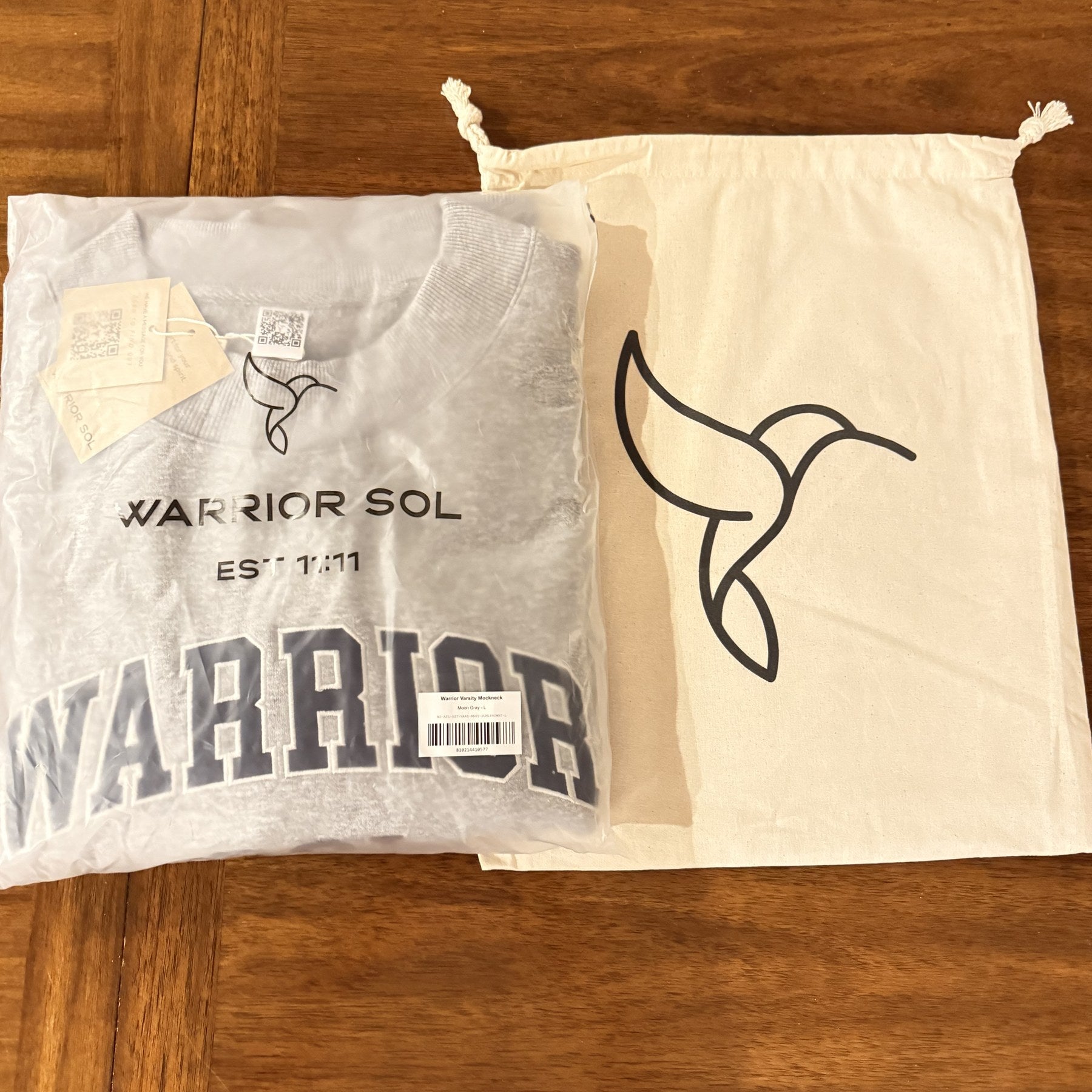 Hummingbird bag next to a folded varsity mockneck for scale